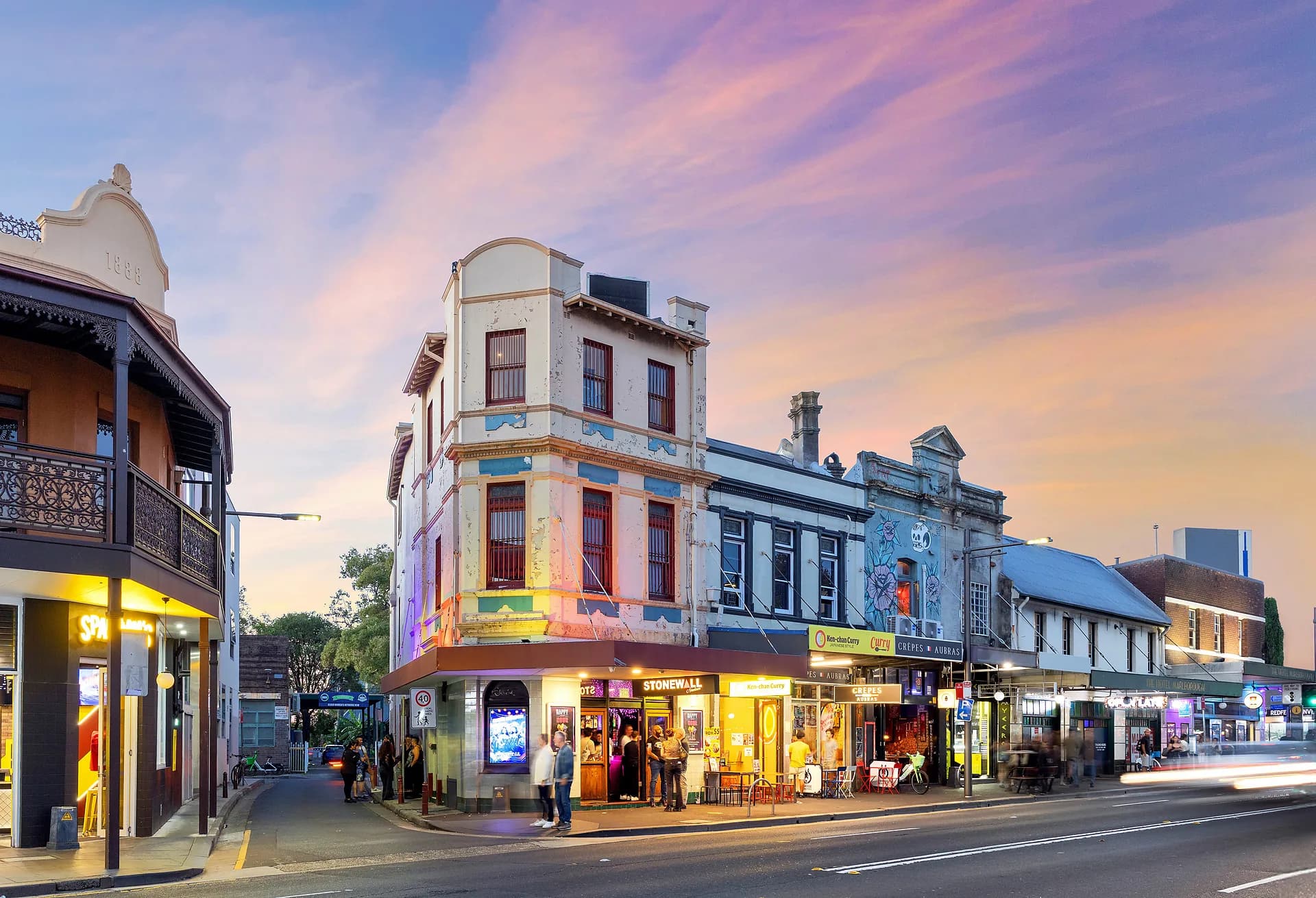Stonewall Newtown at 157 King Street at dusk beneath a pink sky.